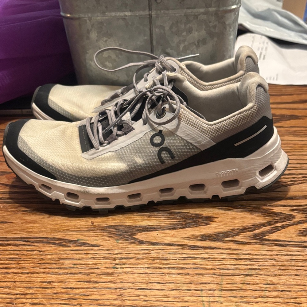 On Running Cream and Black Athletic Shoes